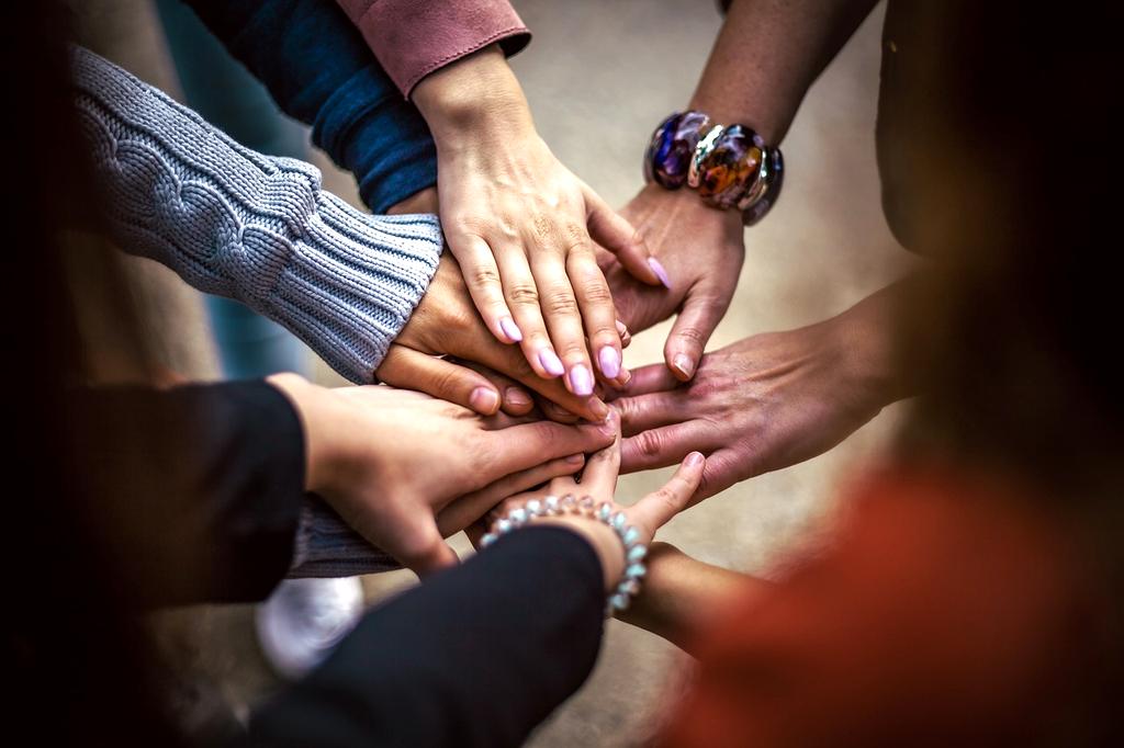 Team collaboration around laptop and digital charts